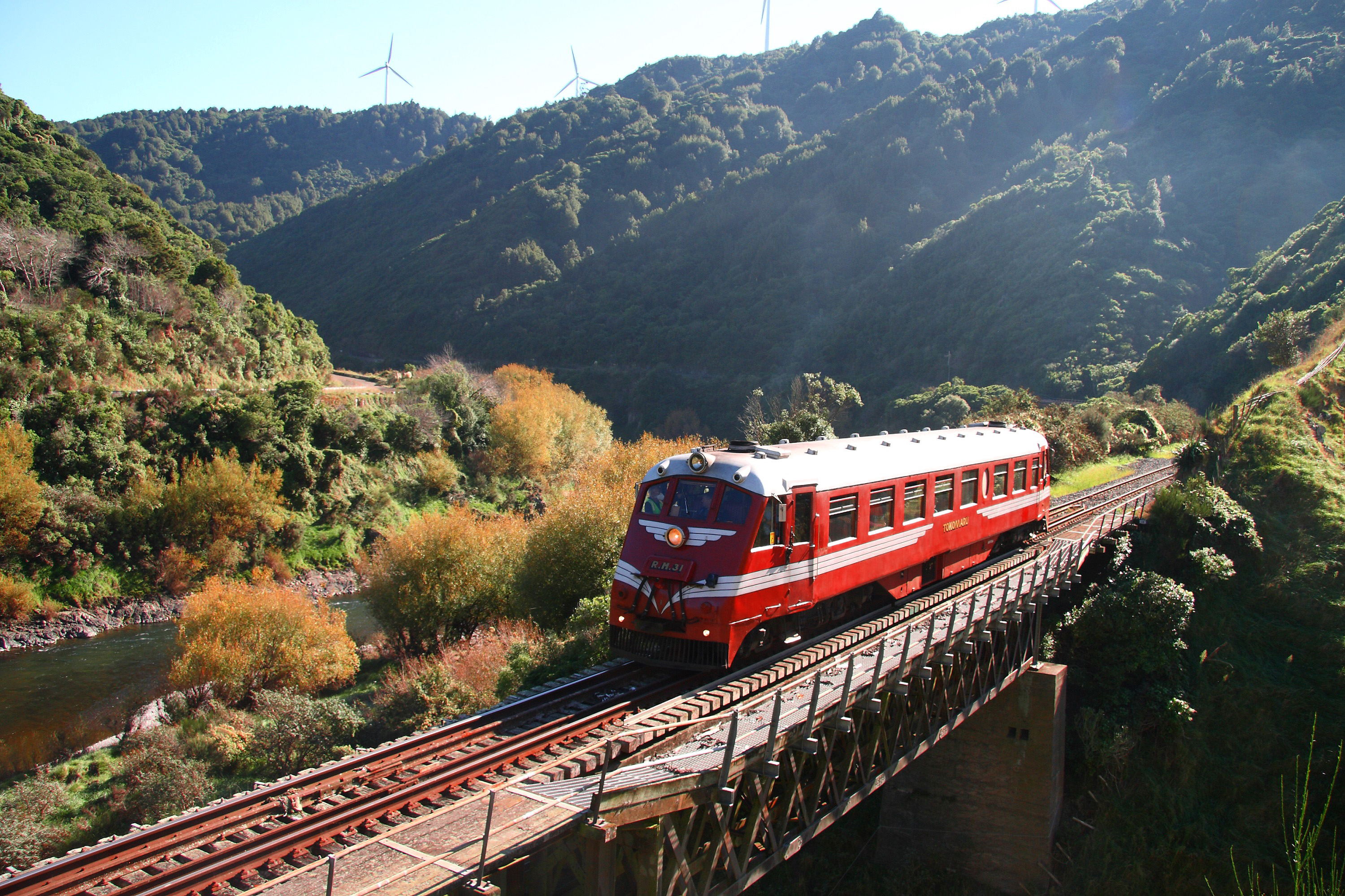 RM 31 Tokomaru Standard Railcar Travelling Across A Bridge With A Landscape Behind